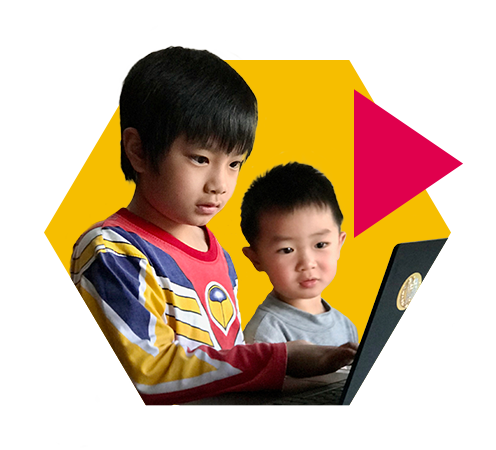 Two young boys playing on a laptop